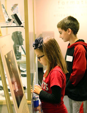 children inspecting exhibit case