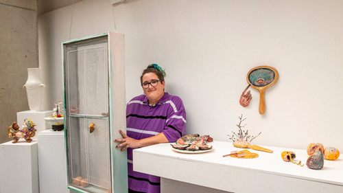 t Lance, curator, with ceramic sculptures by Caro Burks